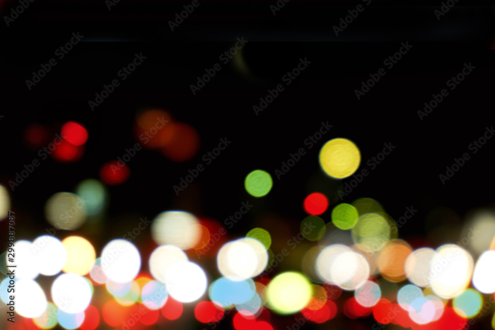 Wall mural abstract colorful bokeh and blurred reflection lighting on black background