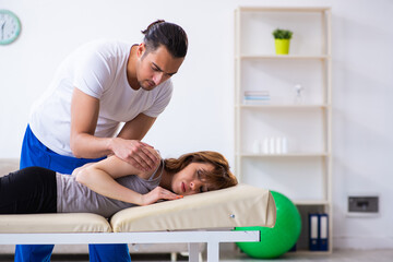 Obraz premium Young woman visiting male doctor physiotherapist