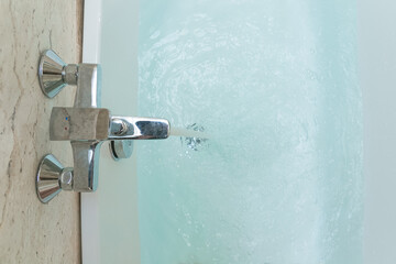 Luxury bath tub and faucet with water