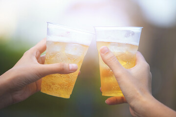 Close-up of Cheers, Cropped image of friends clinking with beer in cafe.