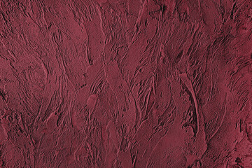 Dark red colored low contrast Concrete textured background with roughness and irregularities to your design or product. Color trend concept.