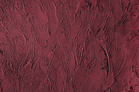 Dark red colored low contrast Concrete textured background with roughness and irregularities to your design or product. Color trend concept.