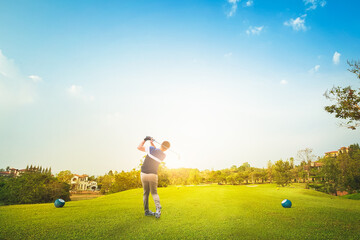 Professional golfer hit sweeping on a golf field.