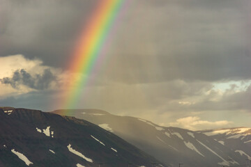 Beautiful rainbow over mountains peak