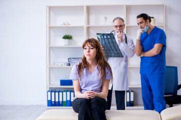 Two doctors examining young woman