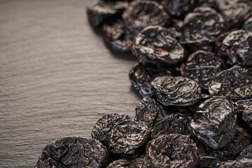 texture of prunes close-up on black