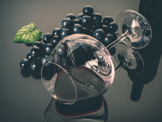 lying vineglass with red grapevine