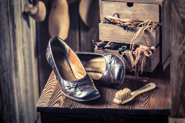 Closeup of shoemaker workshop with shoes, tools and laces