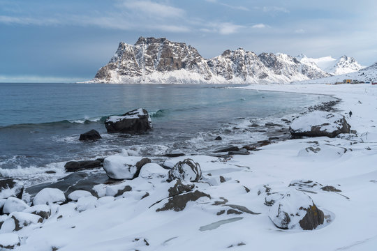 Uttakleiv Beach, with rocks in the fore and mountains in the background. Leknes, Nordland county, Northern Norway, Norway.