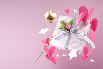 Happy New year magic concept. Christmas gifts, fairy wand, hearts, decorations and toys are fly or fall in the air on a pink background.