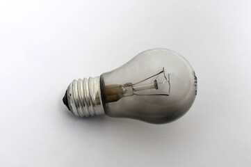 Burnt out light bulb on a white background