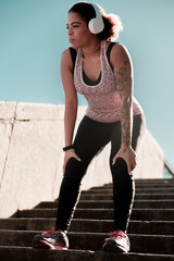 Athletic Afro American woman standing on stairs outdoors