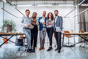 Ready to work! Young business team holds laptops and tablets in their hands in preparation for the...