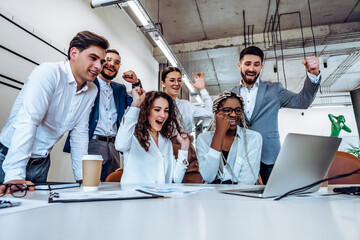 Company development and joy.The concept of success. A group of young business people learned good...