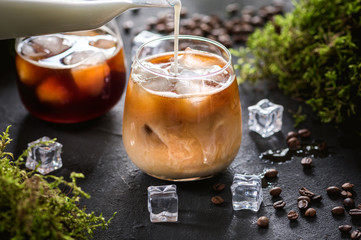 Iced coffee in a glass with cream