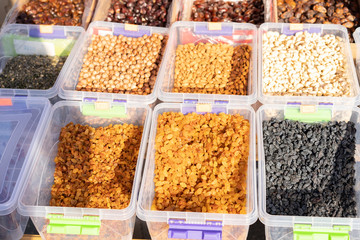 Dried fruits and nuts on a counter for sale.