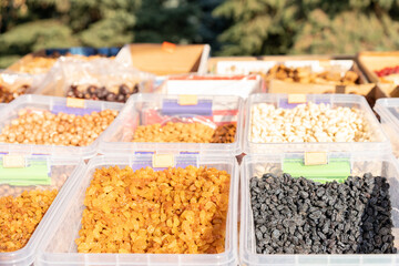 Dried fruits and nuts on a counter for sale.