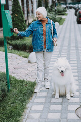 Elderly Caucasian woman spending time with nice dog