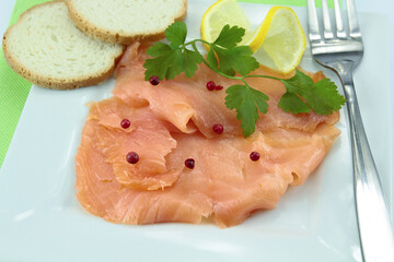 plate of smoked salmon sliced on a table