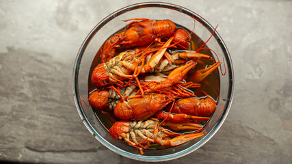 Tasty boiled crayfishes with fennel on table on sackcloth background