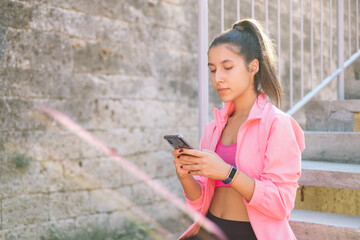 Girl sitting on stairs with mobile phone