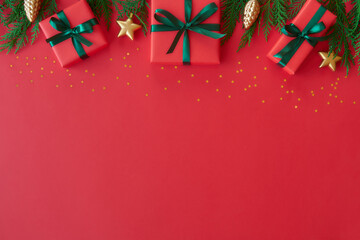 Christmas flat lay background with fir tree, present box and decorations. Free space for design.