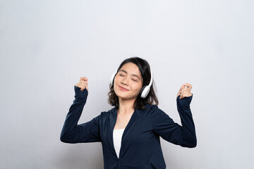 Portrait of a healthy woman with headphones and listening to music isolated on white background