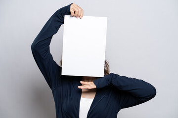 Portrait of a healthy woman showing paper cover her face isolated over white background