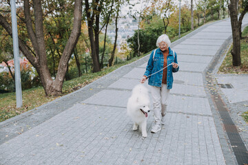 Smiling adult lady spending a weekend with a dog