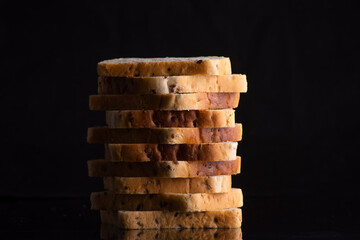 a stack of white bread on a black background