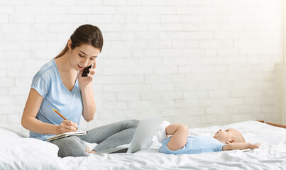 Young mother talking on phone arranging job interview