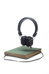 book with headphones. Audiobook concept