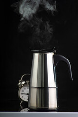 Alarm clock and coffee pot. Coffee time, coffee break concept.