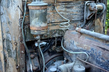Part of vintage car, old timer, very old car, wood. Electrical coil. History.