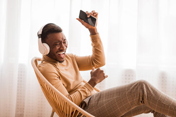 African American Guy Singing Listening Music In Headphones At Home