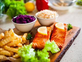 Fried salmon, French fries and vegetables