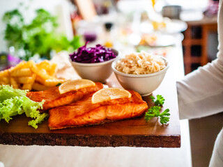Fried salmon, French fries and vegetables