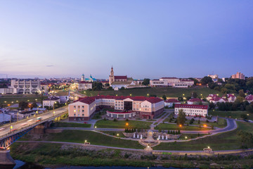 Obraz premium Grodno Regional Drama Theater and Holy Cross Church And Traffic In Mostowaja And Kirova Streets in the morning light. Grodno city in Belarus. Aerial view from a drone