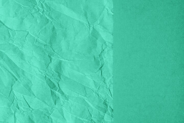 Crumpled and plain paper sheets divided creating line partition. Trendy mint colored abstract background design. Flat lay, copy space. Year color concept.