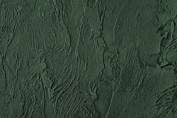 Dark green colored low contrast Concrete textured background with roughness and irregularities to...