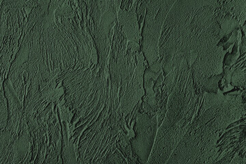 Dark green colored low contrast Concrete textured background with roughness and irregularities to your design or product. Color trend concept.
