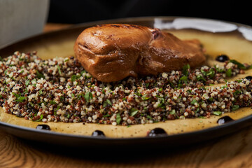 Roasted chicken breast on plate on wooden table background
