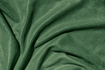 Dark green colored Background of draped fabric with silver lurex thread. Beautiful fashionable...
