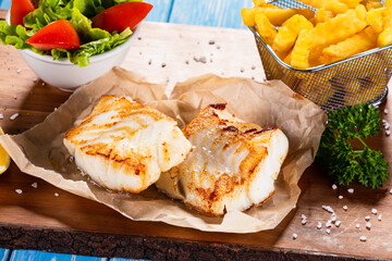 Fish dish - fried fish fillet with french fries and vegetables