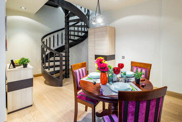 Light studio apartment. Modern interior. Set table. Stairs.