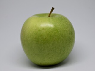 Green apple and Granny Smith variety in the foreground on white background.