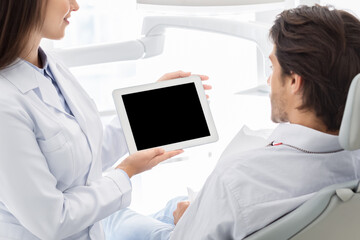 Close up of blank digital tablet screen holding by dentist