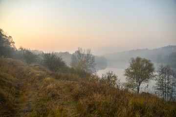 Morning in autumn forest with lake
