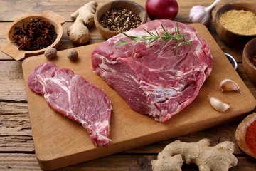 Fotobehang carne cruda di porco su tagliere di legno © denio109