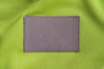 Fototapeta premium laundry care clothing label patch on polyester fabric jersey sport texture